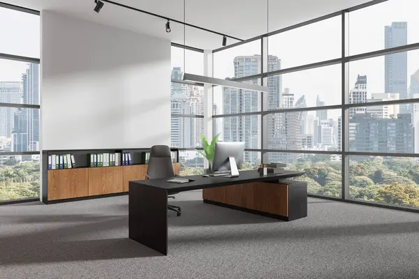 Corner view of office interior with pc computer on desk, armchair on carpet. Stylish ceo work corner with sideboard and panoramic window on Bangkok skyscrapers. Mockup copy space wall. 3D rendering