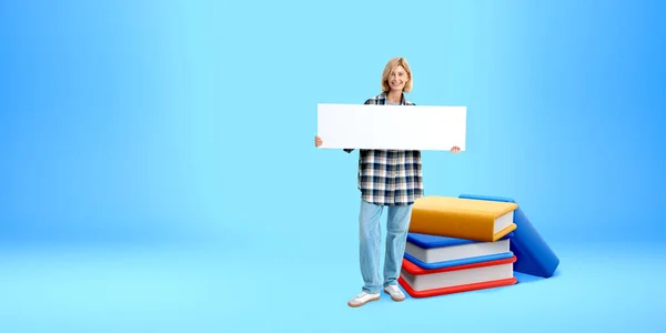 Smiling Woman Showing Mockup Signboard Standing Stack Cartoon Books Blue — Stock Photo, Image