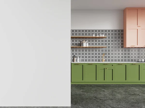 Interior of stylish kitchen with white and tiled walls, concrete floor, comfortable green cabinets with built in sink and cooker and pink cupboards. Copy space wall on the left. 3d rendering