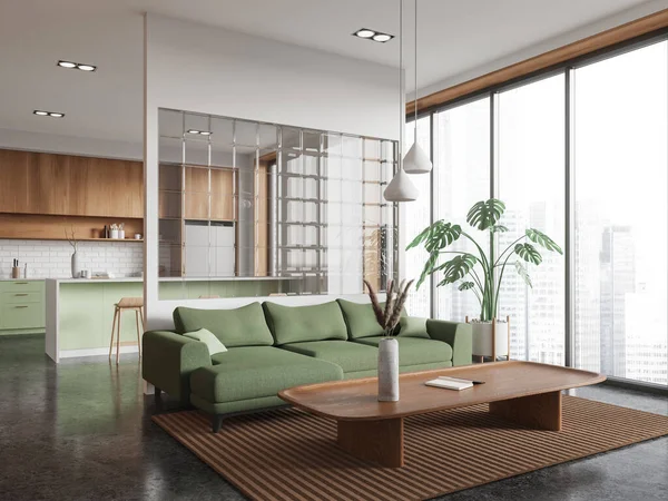Corner view of home studio interior with sofa on carpet, grey concrete floor. Cooking space with bar island and cabinet. Panoramic window on Singapore skyscrapers. 3D rendering