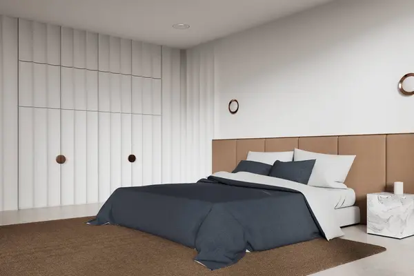 Corner view of hotel bedroom interior bed with bed sheets, carpet on concrete floor. Cozy relax corner with marble nightstand, wardrobe and mock up copy space empty wall. 3D rendering