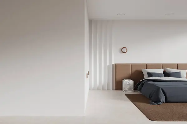 Interior of modern bedroom with white walls, concrete floor, comfortable king size bed with blue cover and copy space wall on the left. 3d rendering