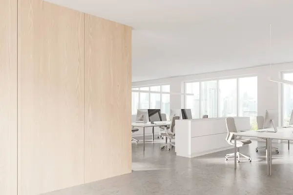 Corner of stylish open space office with white and wooden walls, concrete floor, row of white computer tables and copy space wall on the left. 3d rendering