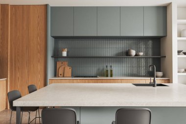 Beyaz ve ahşap duvarları, beton zemini, gri dolapları, dolapları ve tabureli rahat gri adası olan modern mutfağın içi. 3d oluşturma