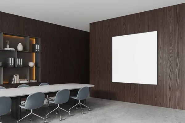 Corner view of wooden conference interior with chairs in row and table, shelf with documents and decoration. Mock up canvas square poster on wall. 3D rendering