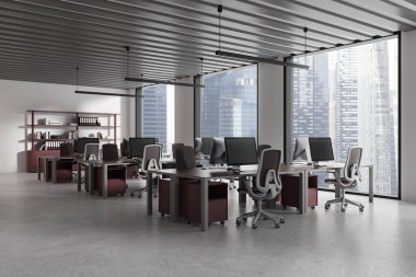 Gri ve kırmızı masa ofislerinin köşesinde sıra sıra bilgisayar masaları ve klasörlü kitaplık var. Eğitim ve iş buluşma alanı. Danışmanlık ve finans. 3d oluşturma