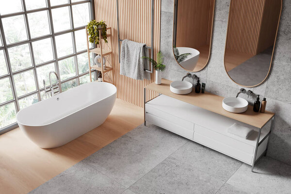 A spacious, modern bathroom interior with a freestanding bathtub, double sink vanity unit, mirrors, and a large window with a garden view. 3D Rendering