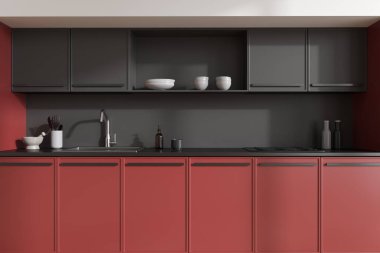 Kırmızı ve siyah modern mutfak, soba ve lavabo, mutfak gereçleri tezgahta. Modern apartmandaki minimalist yemek alanına yakın çekim. 3B görüntüleme