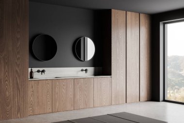 Çift lavabolu ve aksesuarlı banyo manzarası, iki yuvarlak ayna ve gri beton zeminde ahşap raf. Kırsal kesimde panoramik pencere. 3B görüntüleme