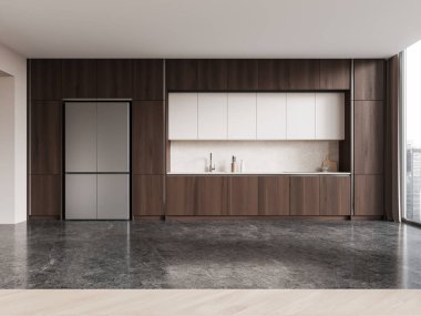 Minimalist ev mutfağı. Ahşap dolap, buzdolabı, gri ışıklı beton zemin. Gökdelenlerde panoramik penceresi olan modern dairede koyu yemek alanı. 3B görüntüleme