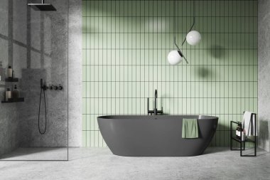 Serbest çalışan koyu küvetli modern banyo, yeşil fayanslı duvar arkası ve minimalist tasarım. Basit ve sakin iç mekan kavramı. 3B Hazırlama