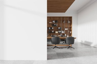 Beyaz ofis odası içi gri koltuklar, ahşap toplantı masası ve döşemeleri beton döşemeli raflar. Boş duvar bölmesini düzenle. 3B görüntüleme