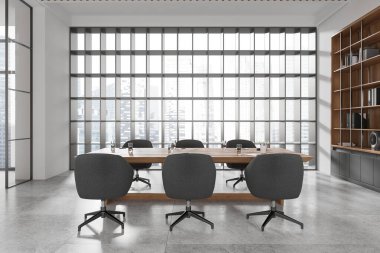 Beyaz ofis odası içi gri yumuşak koltuklu ahşap beton zeminde ahşap toplantı masası. Gökdelenlerin panoramik penceresinin yanında klasörleri olan ahşap bir raf. 3B görüntüleme