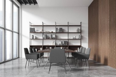 Endüstriyel ofis içi gri yumuşak koltuklu, fayans beton zeminde toplantı masası. Gökdelenlerin panoramik penceresinin yanında klasörleri olan raflar. 3B görüntüleme