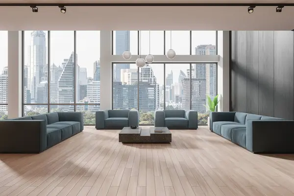 Stock image Stylish office interior blue sofa and soft armchairs, meeting or waiting space with coffee table. Minimalist lobby and panoramic window on Bangkok skyscrapers. 3D rendering