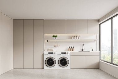 Çamaşır makineleri, minimalist dolapları ve şehir manzarasına bakan geniş bir penceresi olan modern çamaşır odası. 3B Hazırlama