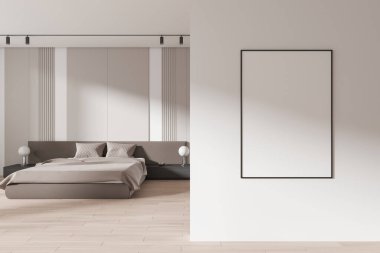 Modern bir yatak odasında beyaz bir duvara boş bir çerçeve, yatak ve komodinli. Minimalist ve temiz tasarım. 3B Hazırlama