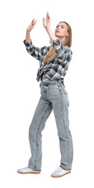 A woman wearing a plaid shirt and jeans is standing with arms raised, isolated on a white background. Casual fashion concept clipart