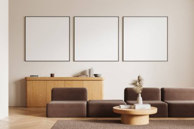 Kahverengi modüler kanepeli bej ev içi oturma odası, halıda kitaplar olan kahve masası, ahşap zemin. İskandinav dinlenme yeri ve üç tane de tuval posterleri. 3B görüntüleme