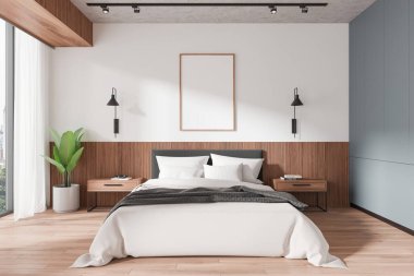 Modern yatak odasının içinde, ahşap aksanlı ve çağdaş dekorlu, düzgün yapılmış bir yatağın üzerindeki duvarda boş çerçeveli bir poster var. 3B Hazırlama