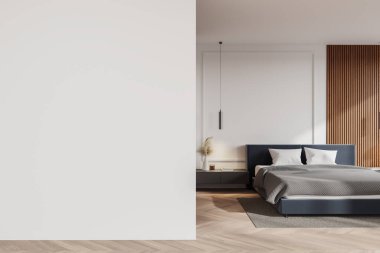 Model için boş beyaz duvarı olan modern bir yatak odası. Oda rahat bir yatak, ahşap aksanlar ve modern iç tasarımı vurgulayan şık bir aydınlatma içeriyor. 3B Hazırlama