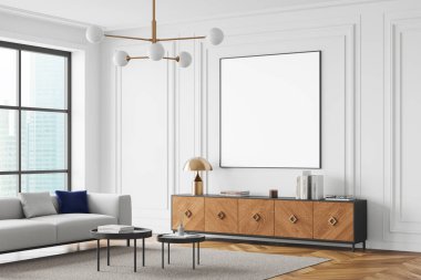 Ahşap büfenin üstündeki beyaz duvarda boş bir posterle modern oturma odası. Gri kanepeli, yuvarlak kahve masalı ve geniş pencereli minimalist tasarım. 3B Hazırlama