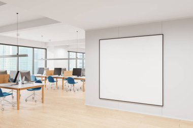 Boş çerçeveli poster modeli modern bir ofiste masaları, sandalyeleri ve bilgisayarları olan beyaz bir duvara asıldı. Ofis iç tasarımı konsepti. 3B Hazırlama