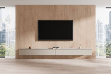 Modern bir oturma odasında, altında parlak, yüzen bir konsol bulunan ahşap paneller üzerinde duvara monte edilmiş bir televizyon bulunur. Büyük pencereler şehir manzarası ve doğal ışık sunuyor. 3B Hazırlama