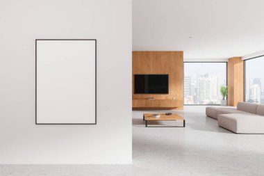 Modern bir oturma odasındaki duvara asılmış boş bir poster modeli, ahşap aksanlar ve minimalist tasarım içeriyor. 3B Hazırlama