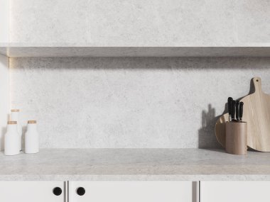 Tabaklar ve mutfak gereçleri olan minimalist bir ev mutfağı. Kesme tahtası ve tabakları olan gri bir tezgah. Modern apartmandaki yemek pişirme alanına yakın. 3B görüntüleme