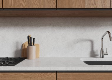 Açık ev mutfağı içinde lavabo ve gaz sobası, boş gri taş tezgahta bıçaklar. Modern apartmandaki minimalist yemek dolabının kapanışı. Model ürün görüntüsü. 3B görüntüleme