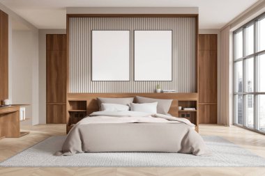 Yatağın üstünde iki boş poster, ahşap mobilyalar ve rahat bir ortamda büyük pencereler olan modern bir yatak odası. 3B Hazırlama