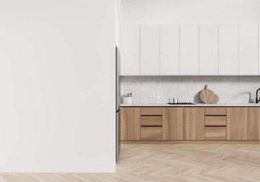 Ahşap dolaplar, beyaz dolaplar ve boş bir duvarın olduğu gösterişli, modern bir mutfak. Tarafsız bir arkaplan karşısında minimalist bir dekor. 3B Hazırlama