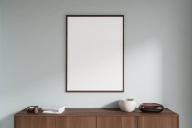 Ahşap bir dolaptaki boş çerçeveli poster. Arkaplanda kitaplar ve dekorlar var. İç dekorasyon kavramı. 3B Hazırlama
