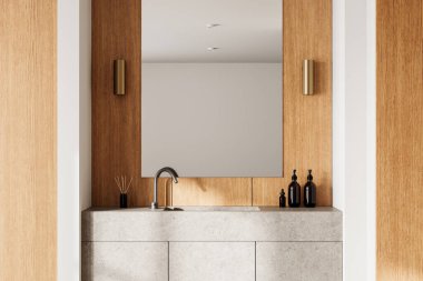 Ahşap paneller ve taş bir lavabo ünitesi olan şık bir banyo. Tarafsız bir arkaplanda sabun spreyleri olan minimalist tasarım. 3B Hazırlama