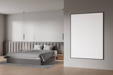 Modern yatak odasının içinde duvarında boş bir poster var. Gri tonları ve ahşap döşemeleri olan minimalist bir tarz. İç tasarım kavramı. 3B Hazırlama