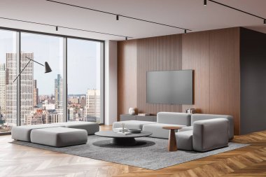 Minimalist gri kanepe, yuvarlak kahve masası ve şehir manzaralı geniş pencereli modern bir oturma odası. Duvarlardaki kahverengi tahta paneller şehir ev tasarımının temiz ve modern estetiğini geliştirir. 3B Hazırlama