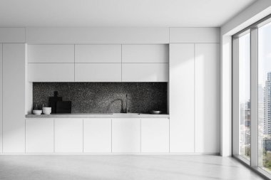 Minyatür modern mutfak, beyaz dolap, siyah taş arka plan, geniş pencere manzarası ve beton zemin. Ev lüksü ve yemek yapma kavramı. 3B Hazırlama