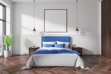 Yatağının üstünde boş çerçeveli bir poster olan, ahşap döşeme ve minimalist mobilyalarla süslenmiş modern bir yatak odası. 3B Hazırlama