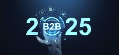 Görüntü 2025 yılını B2B konseptiyle gösteriyor, el ele tutuşan dijital simgeler. Karanlık bir arka planda fütürist grafik tarzı. Gelecekteki iş stratejilerini temsil ediyor