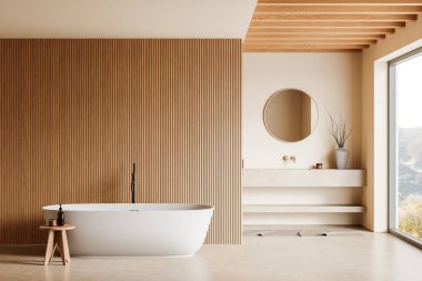 Serbest banyo küveti, yuvarlak ayna, ahşap tahta duvar ve bej tonlarıyla modern banyo. Geniş pencereden görünen doğal manzara. 3B Hazırlama