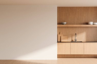 Boş beyaz duvarı ve ahşap dolapları olan minimalist bir mutfak. Tezgahında dekor olan hafif ahşap dokular. Kopya alanı için boş duvar. 3B Hazırlama