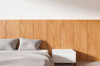 Kalıplı gri yastıklar, açık ahşap duvar panelleri, minimalist beyaz bir komodin ve sıcak ve modern bir atmosfer yaratan yumuşak bir yatak odası. 3B Hazırlama.