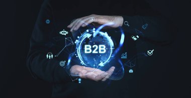 Parlak B2B dijital simgeleri ve küreyi tutan eller, koyu arkaplanı olan fütüristik stil, iş, teknoloji ve ağ kavramlarını temsil eden