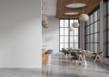 Yuvarlak ahşap masaları, şık sandalyeleri, bir bar alanı ve geniş pencereleri olan çağdaş bir kafe. Asılı küresel ışıkları olan minimalist tasarım. 3B Hazırlama