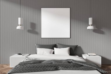 Modern bir yatağın üzerinde, minimalist bir yatak odasında beyaz ve gri yatak örtüsü olan gri bir duvarda boş bir poster. Sıcak ışıklandırma, iç tasarım konsepti. 3B Hazırlama.