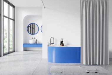 Mavi bir kibir ve banyo küveti, yuvarlak aynalar, gri bir zemin ve büyük pencerelerden süzülen doğal ışık içeren zarif bir banyo tasarımı. 3B Hazırlama