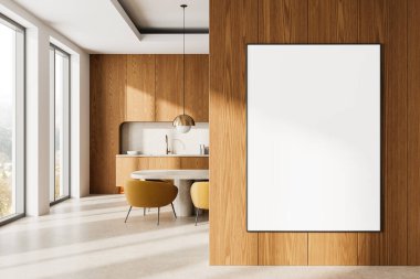 Ahşap bir duvarda asılı boş çerçeveli poster modeli modern bir mutfak içinde bir yemek masası ve sandalyeler, doğal güneş ışığı. 3B Hazırlama.