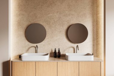 Çift lavabolu minimalist banyo, yuvarlak aynalar, ahşap dolaplar ve sıcak tonlu duvarlar. Çağdaş dekor modern tasarımın altını çizmektedir. 3B Hazırlama.