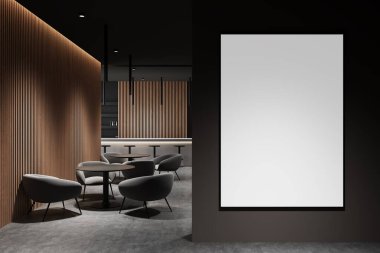 Ahşap panelli, yumuşak koltuklu ve ortam aydınlatmalı çağdaş bir iç mekanda karanlık duvarda boş bir poster şablonu. Tasarım modelleri ve planlar için ideal. 3B Hazırlama.